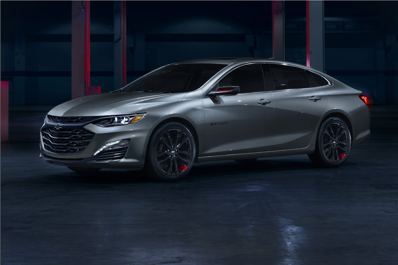 2024 Chevrolet Malibu Redline Edition parked in showroom with red lighting.