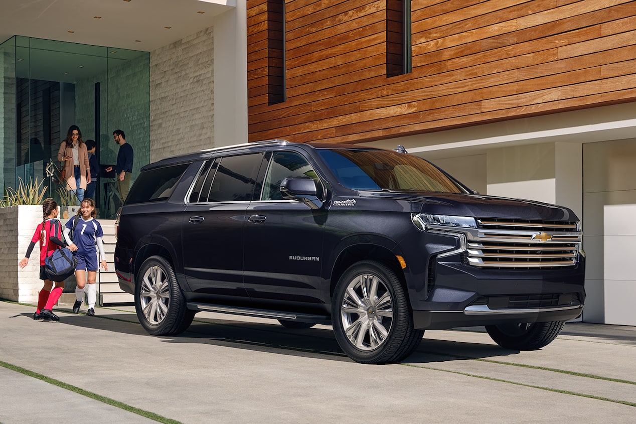 The 2024 Chevrolet Suburban on standby outside a house.