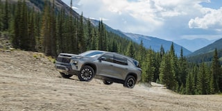 2024 Chevy Traverse Driving Uphill with Mountains in the Background