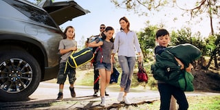 A Family Unloading Camping Gear from the Trunk of their 2024 Chevy Traverse 