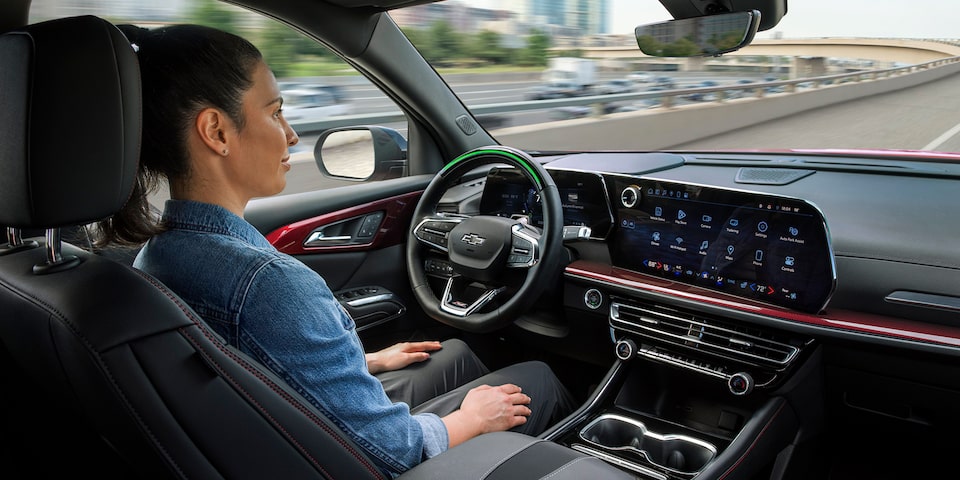 A woman using the Super Cruise technology inside a 2024 Chevrolet Traverse.