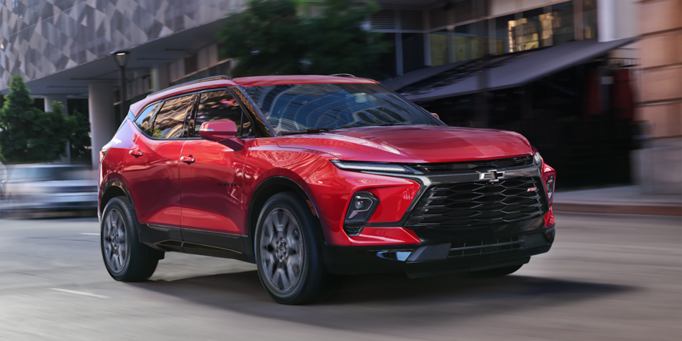 Front-side view of the 2025 Chevrolet Blazer driving fast in the city.