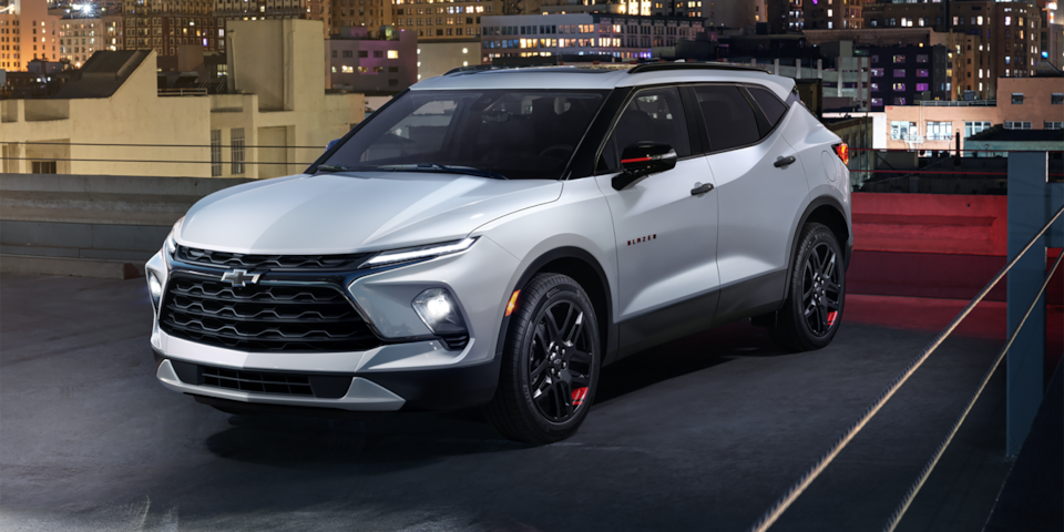 Front-side view of the 2025 Chevrolet Blazer driving at night in the city.