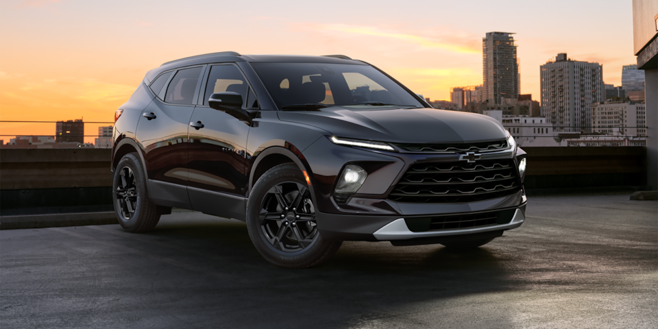 Front-side view of the 2025 Chevrolet Blazer parked outdoors in the city during sunset.