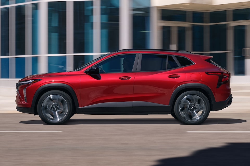 Side profile shot of the 2025 Chevrolet Trax by an office.