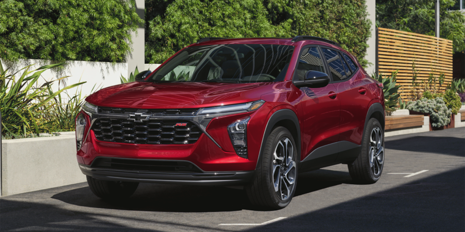 The 2025 Chevrolet Trax parked beside a house.