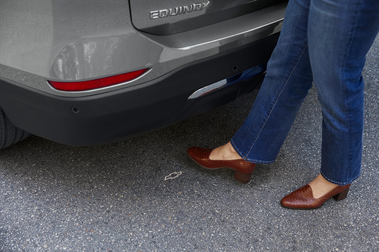 A person activates the convenient hands-free power liftgate with their foot.