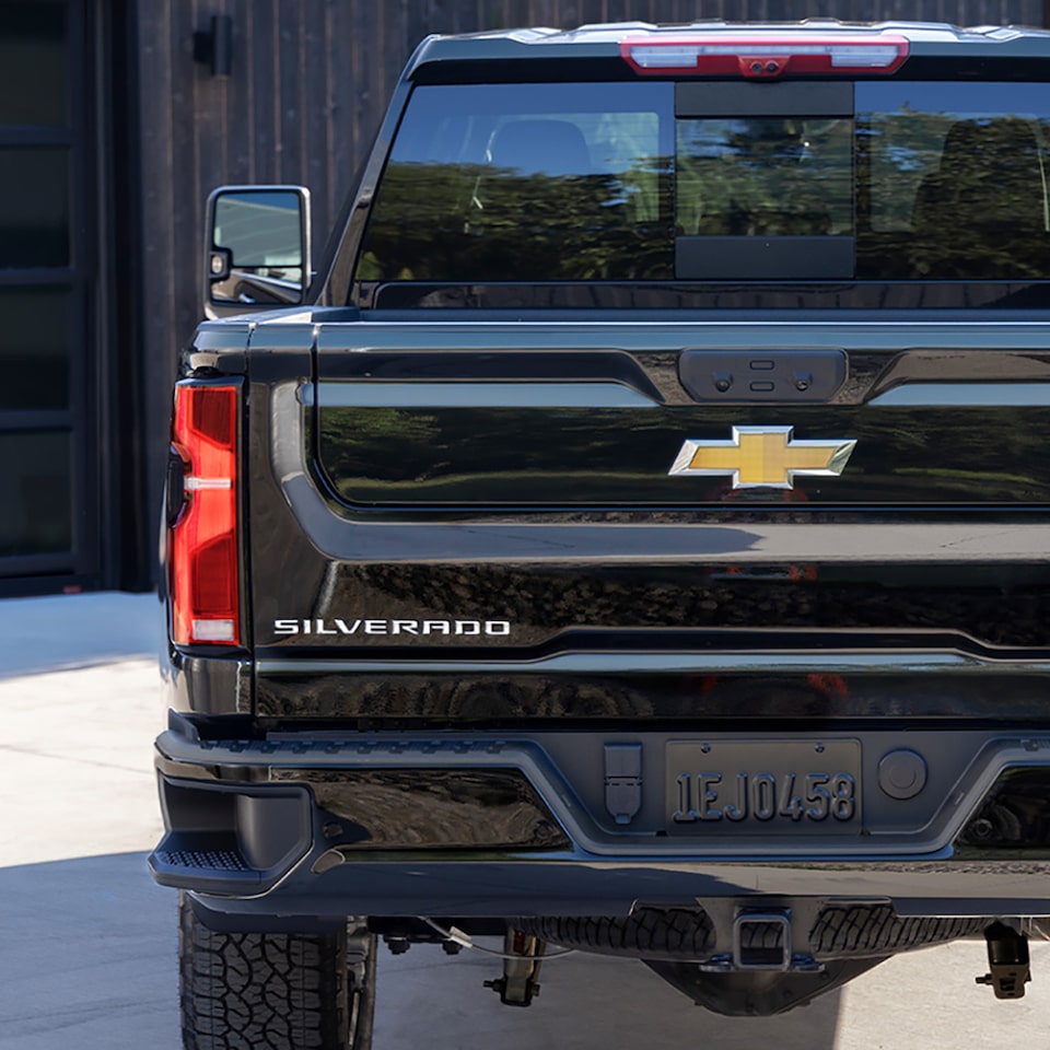 Back view of the 2025 Chevrolet Silverado HD pickup truck parked outdoors.