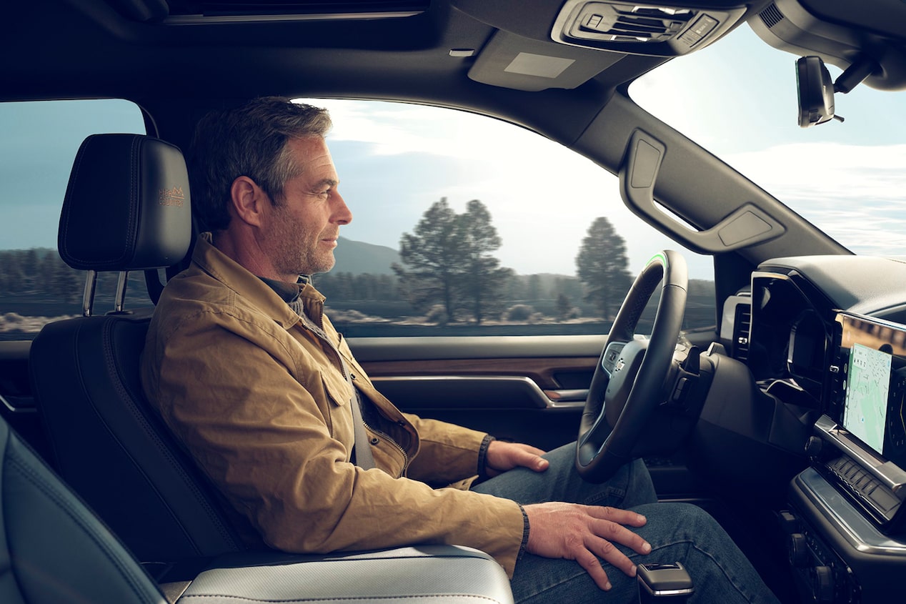 A person utilizing the hand-free driving technology of the 2024 Chevrolet Silverado.