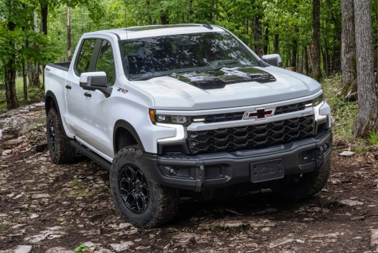 Silverado ZR2 Bison driving off-road in the woods.