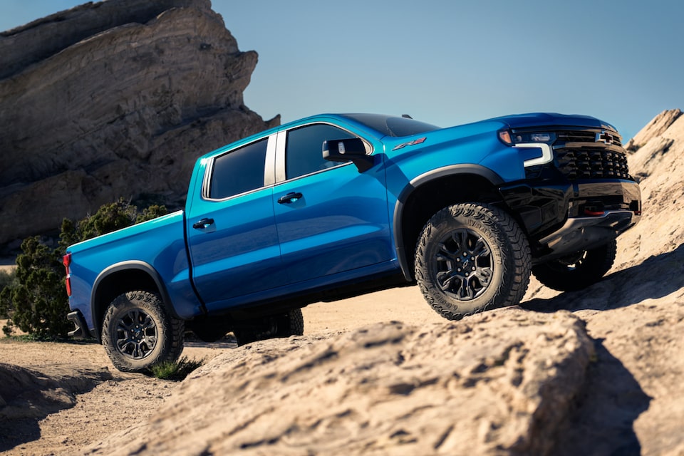 Chevrolet Silverado ZR2 driving uphill on rocky terrain.