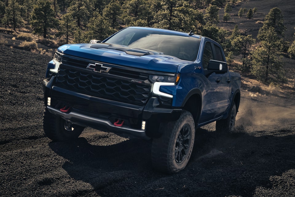 Chevrolet Silverado ZR2 speeding quickly through off-road terrain.