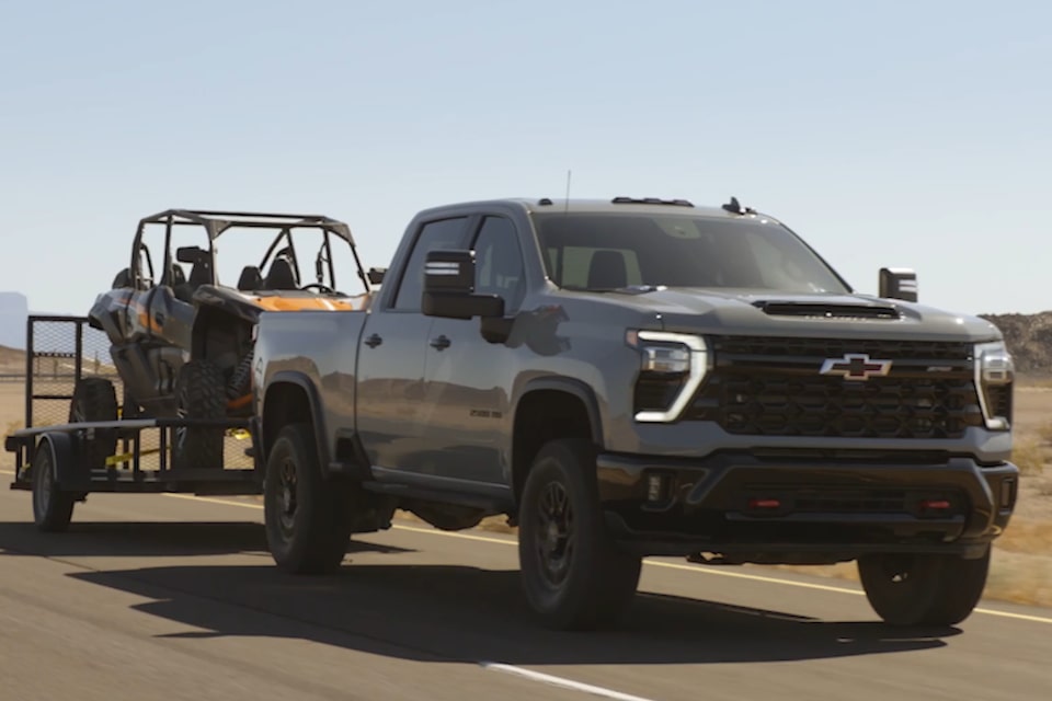 Chevrolet Silverado HD ZR2 towing an off-road vehicle.