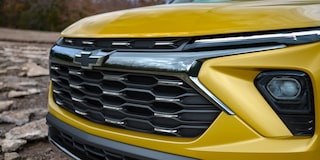 Close-up view of the high-gloss black mesh grilles of the 2024 Chevrolet Trailblazer.