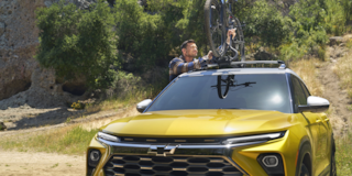 A person mounting his bike on the roof of the 2024 Chevrolet Trailblazer.