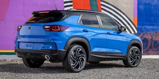 The 2024 Chevrolet Trailblazer parked beside a graffiti-lined wall.