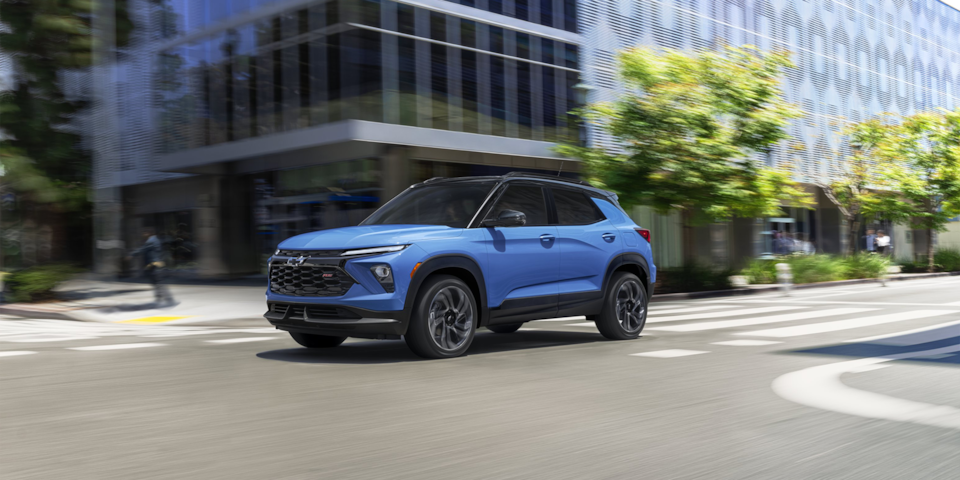 The 2024 Chevrolet Trailblazer driving past a spacious intersection.