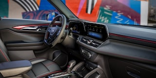 Front passenger's perspective of the red interior accents of the 2024 Chevrolet Trailblazer.