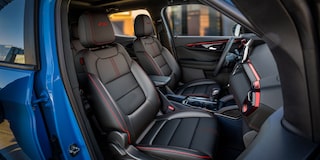 Outsider's view of the red-lined interiors of the 2024 Chevrolet Trailblazer.