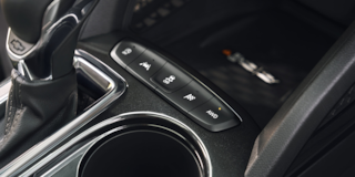 Close-up view of the buttons near the gear stick of the 2024 Chevrolet Trailblazer.