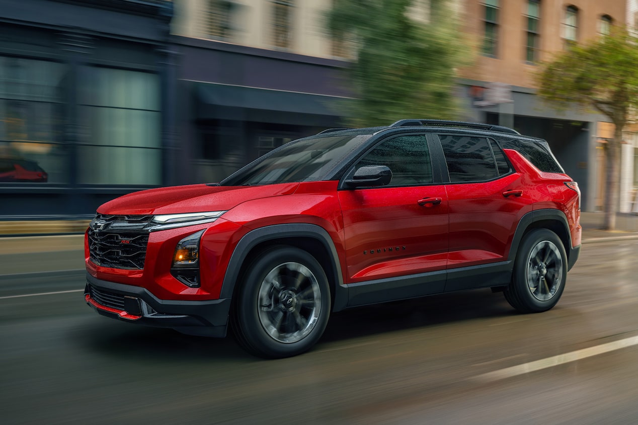 2025 Chevrolet Equinox compact SUV driving alone on a city street.