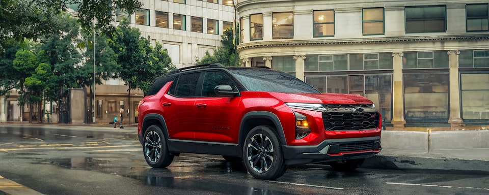 2025 Chevrolet Equinox compact SUV parked alone on a city street on a rainy day.