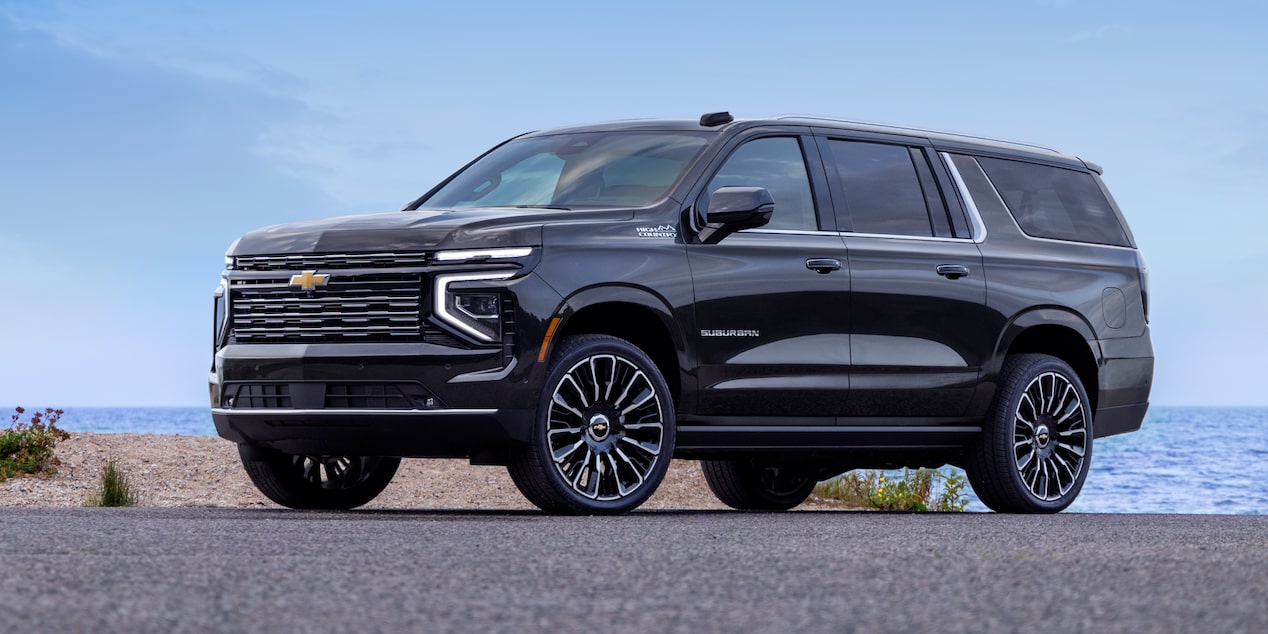 Front-side view of the 2025 Chevrolet Suburban SUV parked near a body of water.