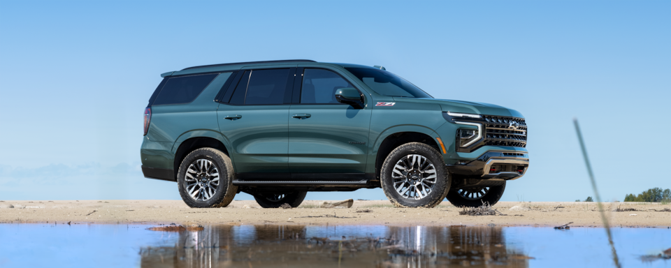 Front-side view of the 2025 Chevrolet Tahoe SUV parked on a Gravel Path.