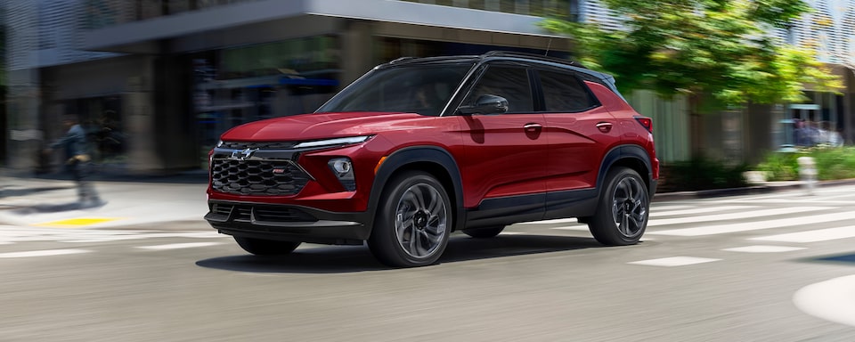 2025 Chevrolet Trailblazer driving through a city intersection.