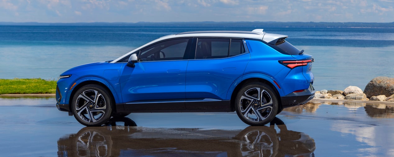 Side view of a 2025 Chevrolet Equinox EV parked next to a shoreline.