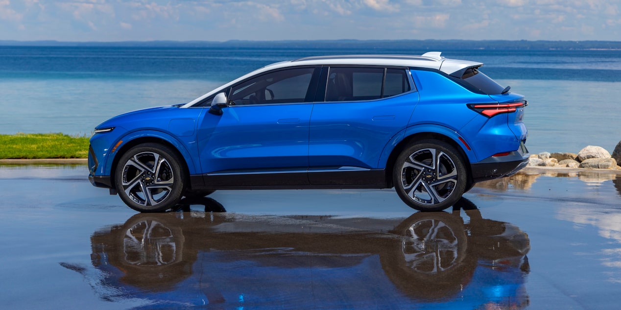 Side View of a 2025 Equinox EV parked next to a shoreline.