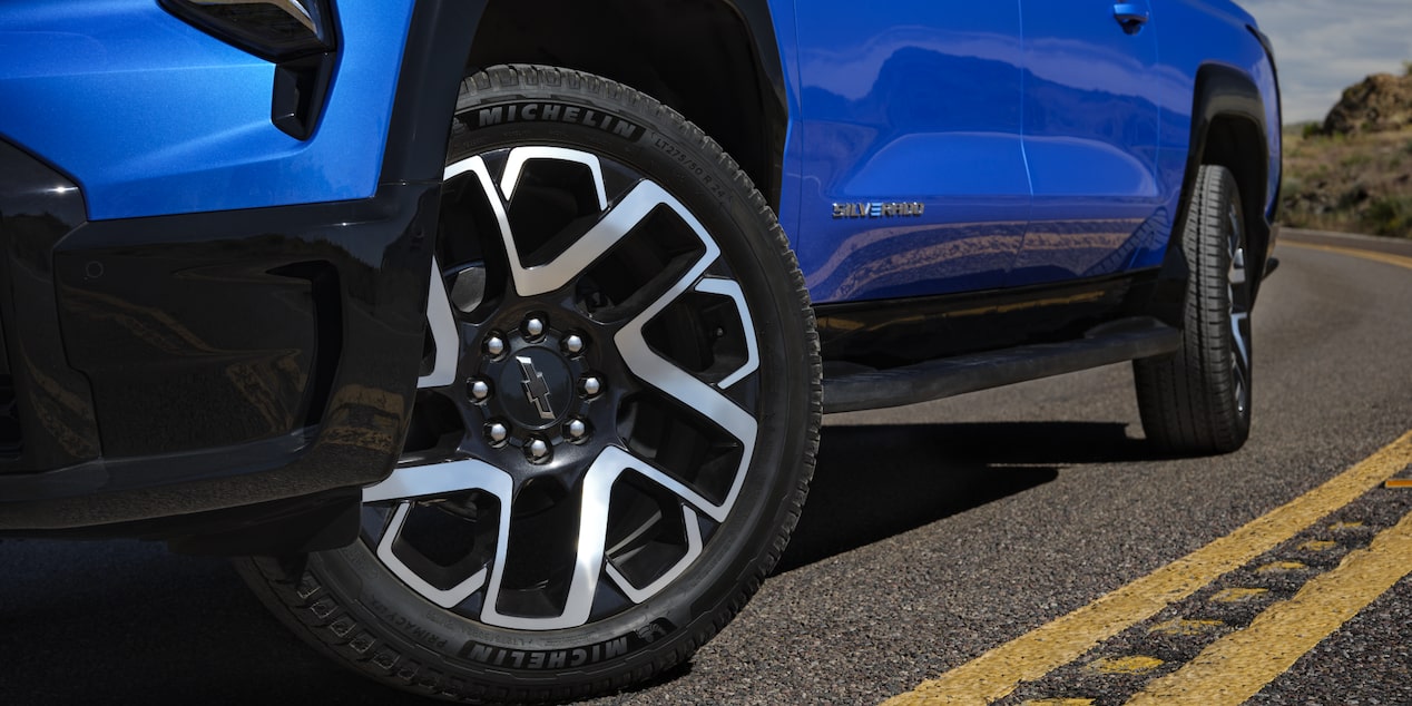 Low angle view of the tires of a 2025 Chevrolet Silverado EV on a road.