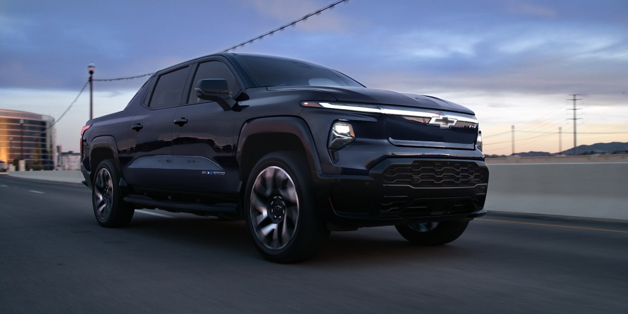 Front-side view of a 2025 Chevrolet Silverado EV driving alone on the road.