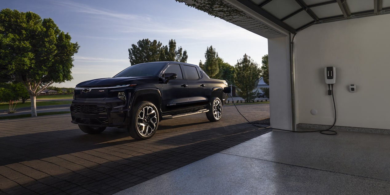 A 2025 Chevrolet Silverado EV getting charged at a home garage.