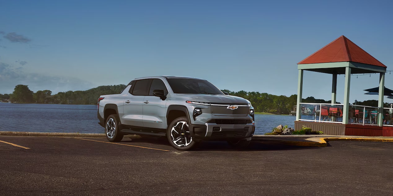 Front-side view of a 2025 Chevrolet Silverado EV with mountains in the distance.