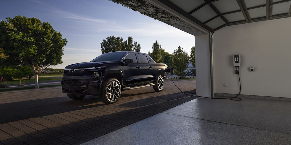 Chevrolet Silverado EV  charging in a home garage.