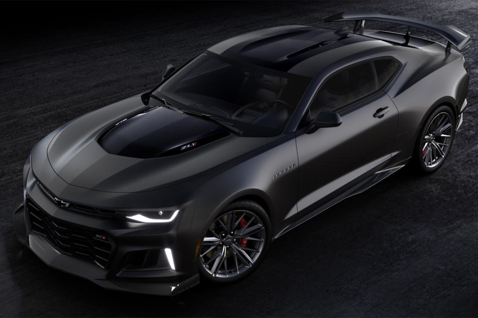 Birds eye view of the 2024 Chevrolet Camaro ZL1 parked in a warehouse with its headlights on.