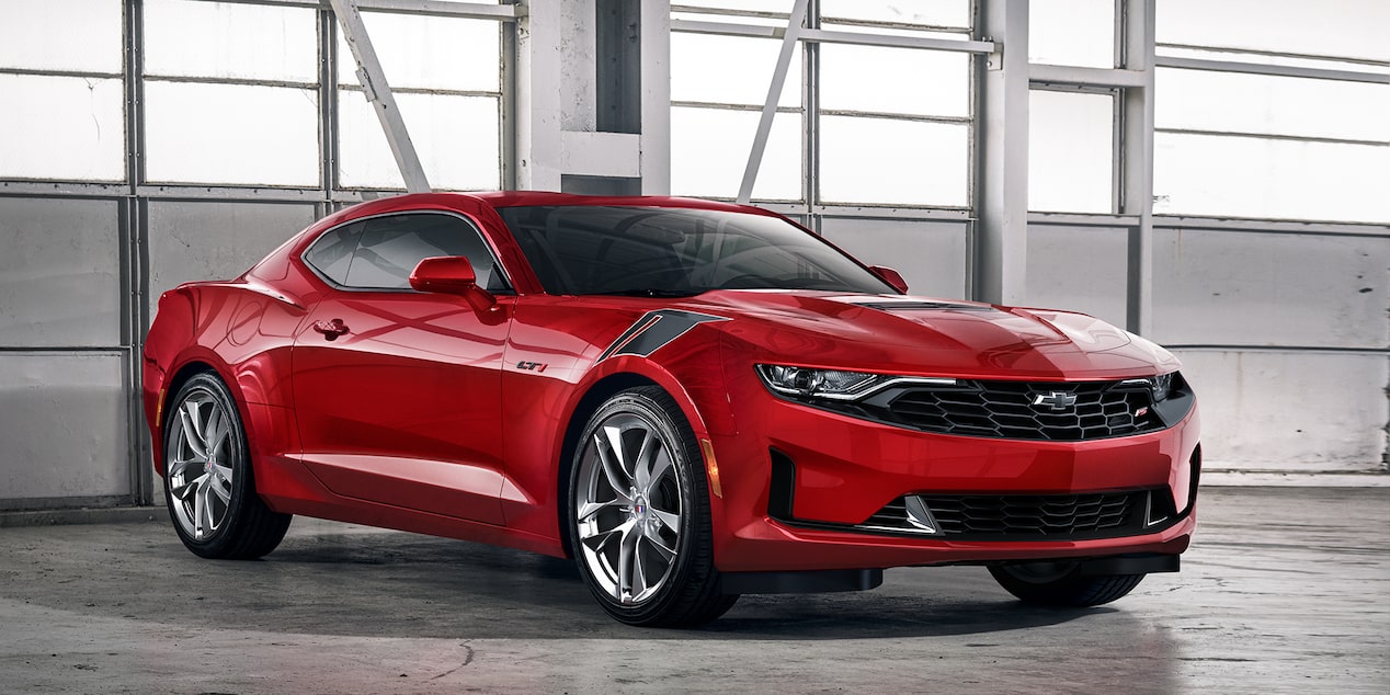 Red-colored 2024 Chevrolet Camaro parked in a garage during daylight.