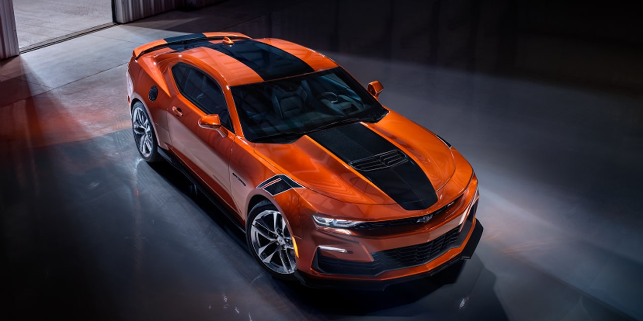 Birds eye view of the vivid Orange Metallic 2024 Chevrolet Camaro parked in a warehouse.