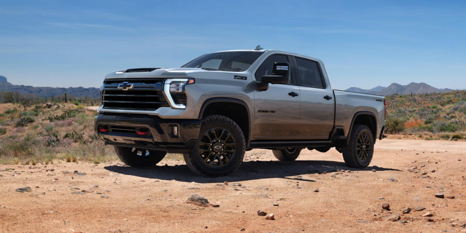 Front-side view of the 2025 Chevrolet Silverado HD Trail Boss pickup truck parked alone outdoors.