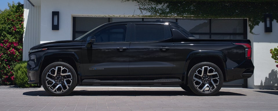 Side-profile view of the 2024 Chevrolet Silverado EV parked in a driveway.