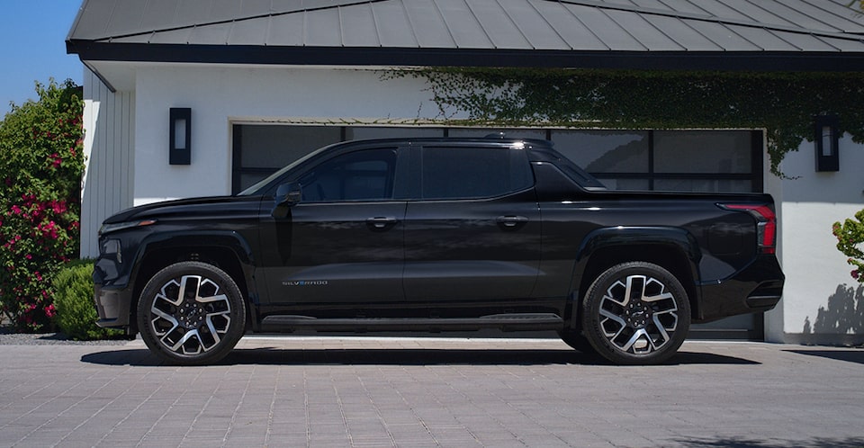 Side-profile view of the 2024 Chevrolet Silverado EV parked in a driveway.