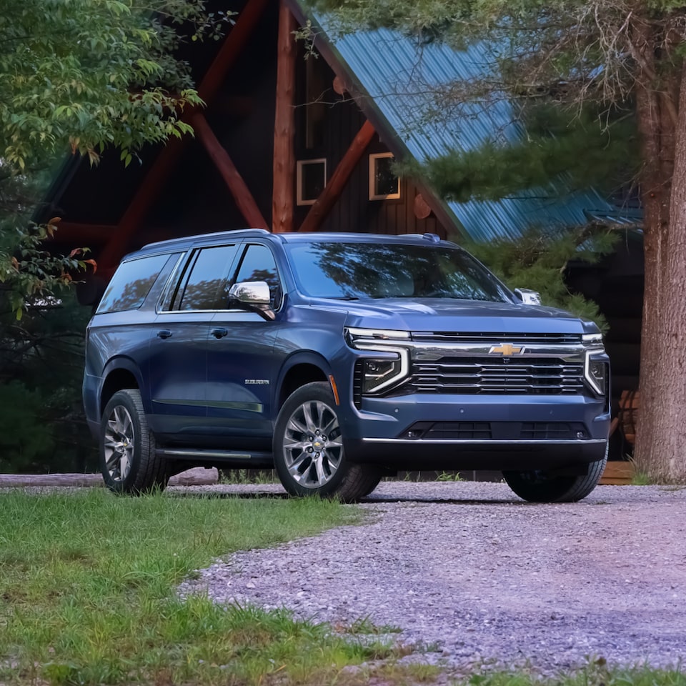 Front Three-Quarters View of the 2025 Chevrolet Suburban SUV Parked on a Gravel Road