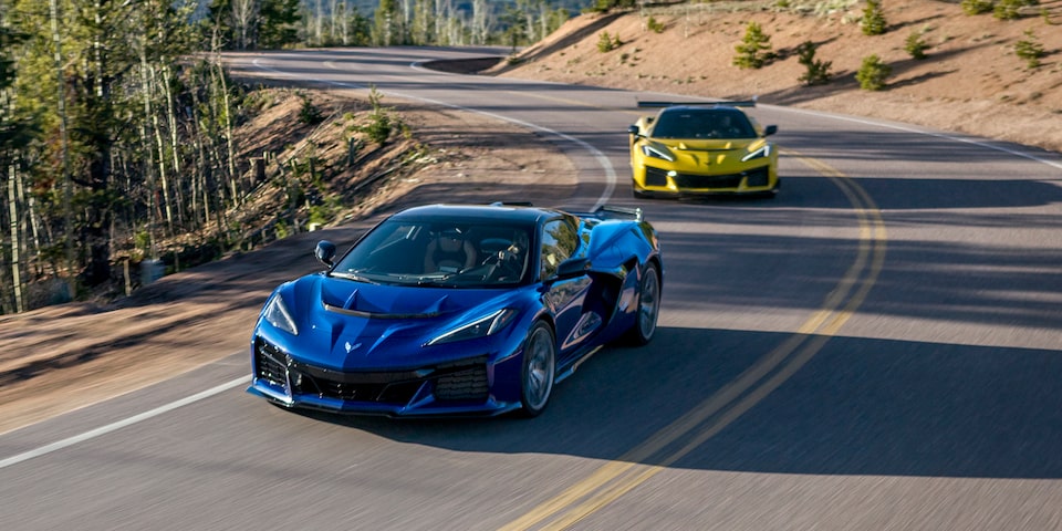 Two 2025 Chevrolet Corvette ZR1 vehicles driving on a hillside road.