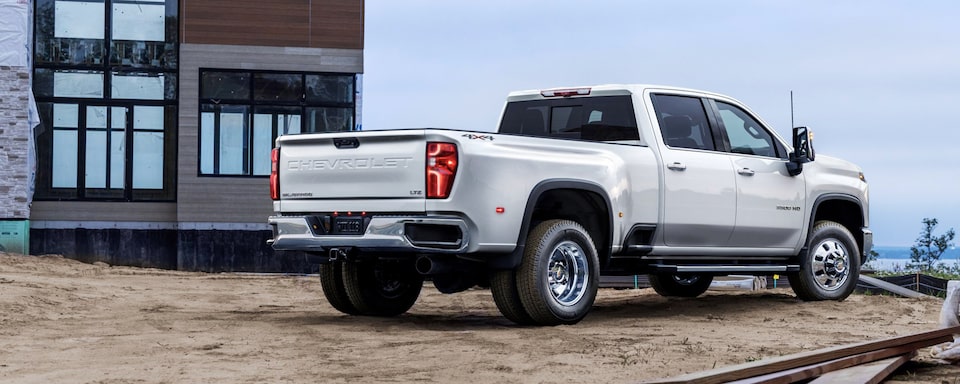 Rear 3/4 View of Summit White 2024 Silverado HD on Job Site