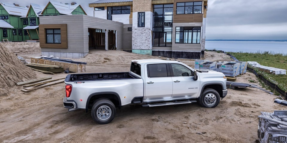 Passenger Side View of The Summit White Silverado HD On the Jobsite