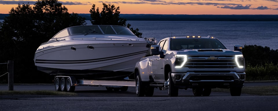 The 2024 Summit White Silverado HD Leaving the Lake while Hauling a Boat