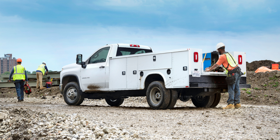 Unloading equipment from the 2024 Chevrolet Silverado 3500 Chassis Cab.