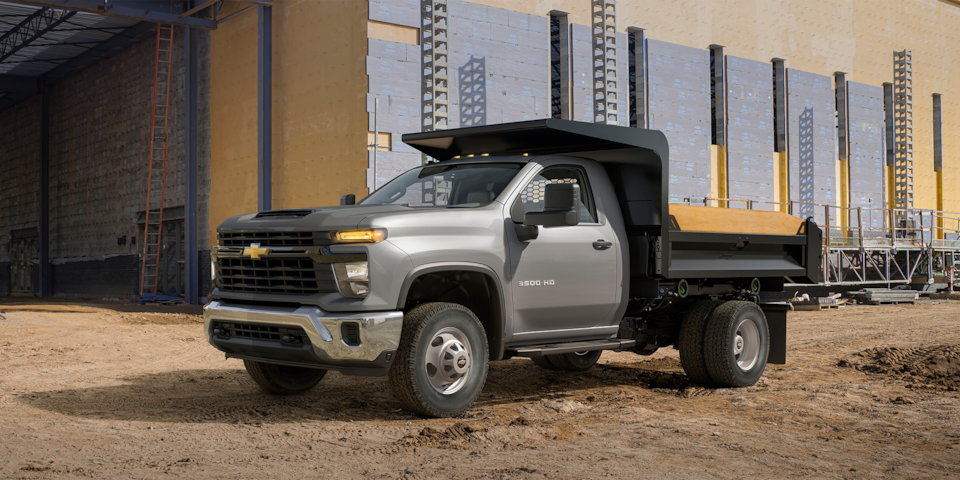 2024 Chevrolet Silverado 3500 Chassis Cab parked at a construction worksite.