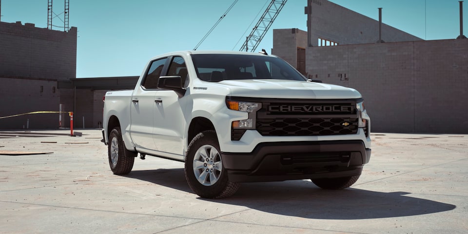 2025 Chevrolet Silverado LD Work Truck parked at a construction site.